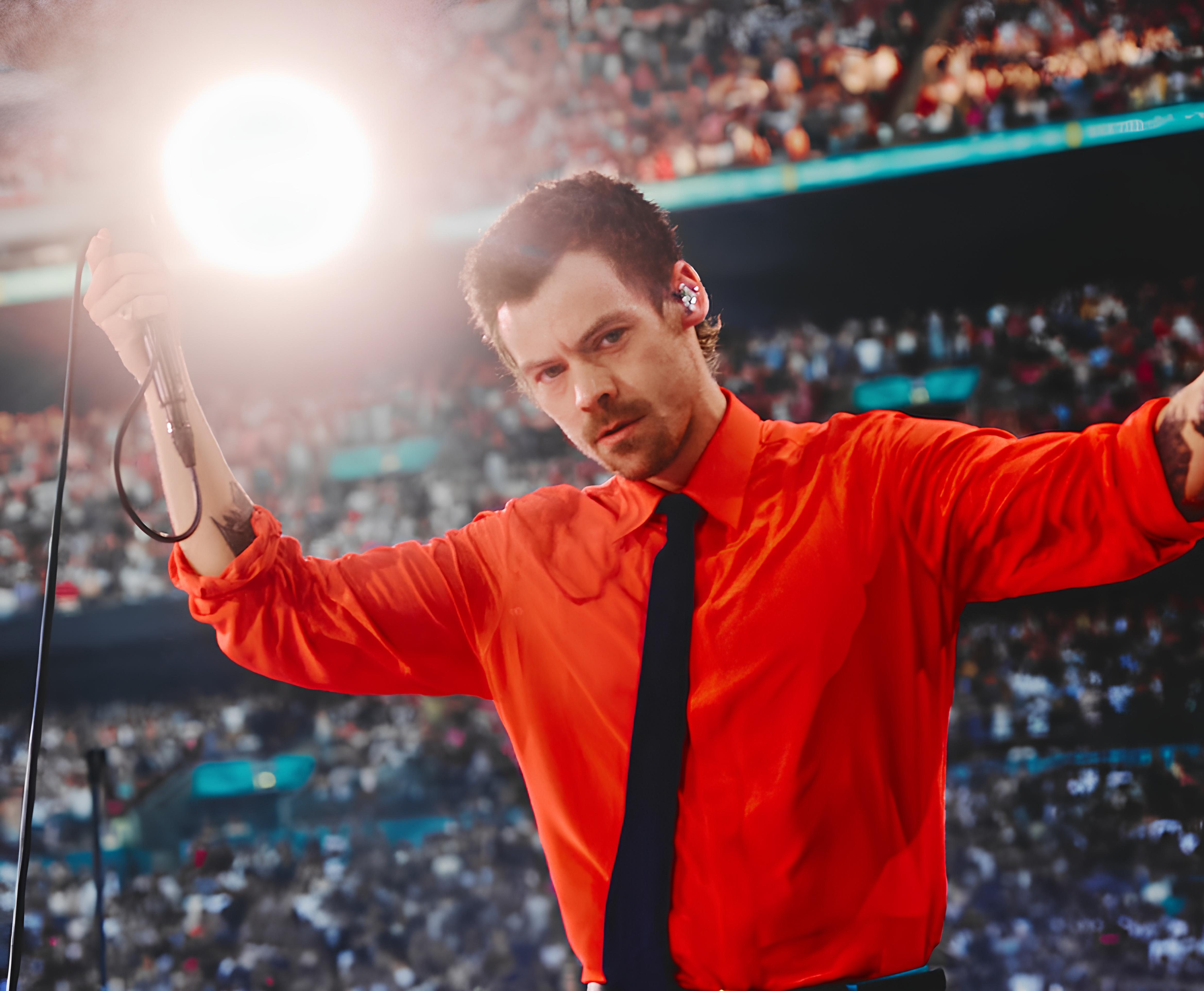 Harry Styles performing at Wembley in a red Valentino shirt and black tie on the Together, Together tour