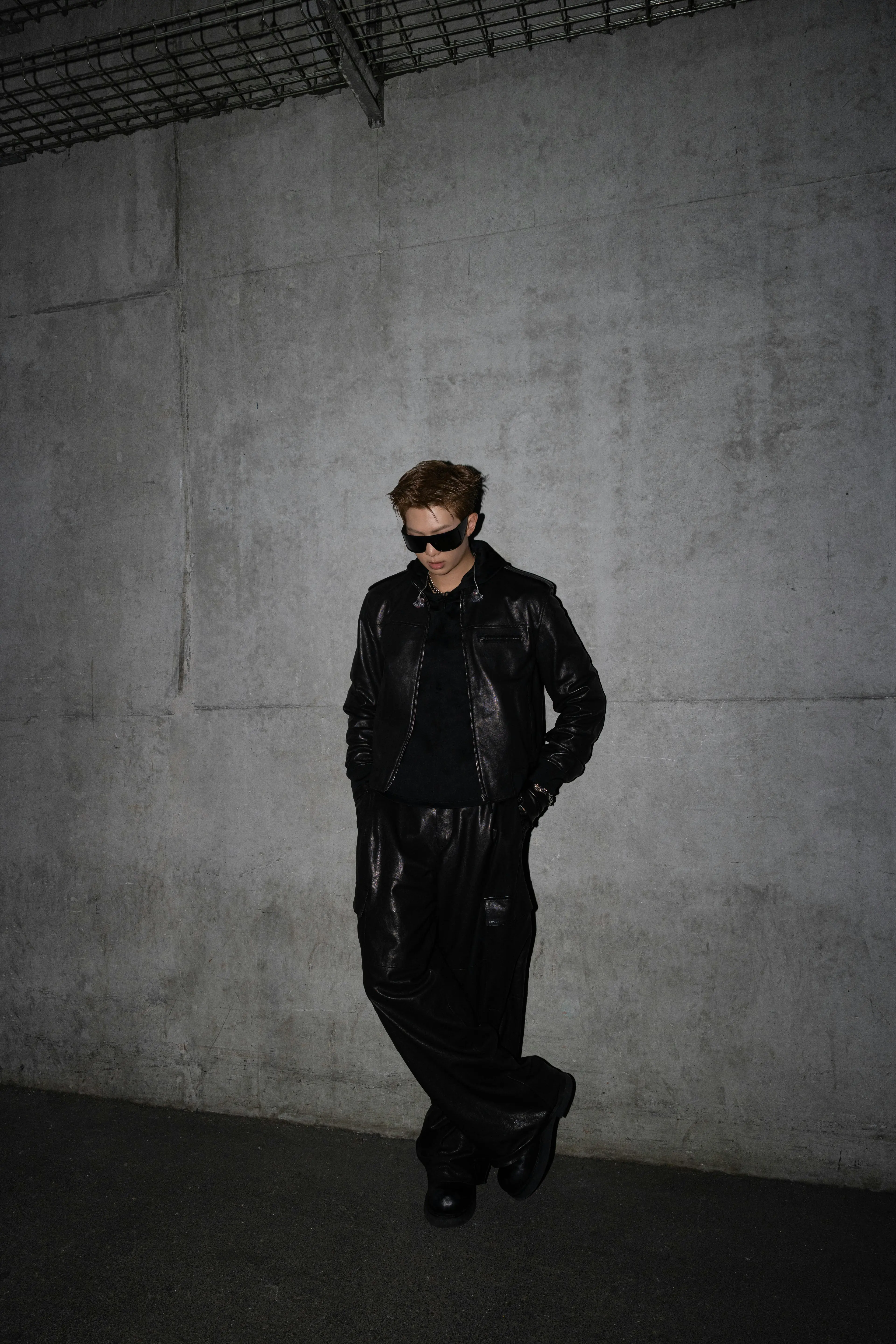 BTS ARIRANG: Inside the Looks of the World Tour Vanity Teen 虚荣青年 RM of BTS wearing a custom black Gucci leather bomber jacket with cargo pants and a black hoodie during the ARIRANG World Tour in Paris.
