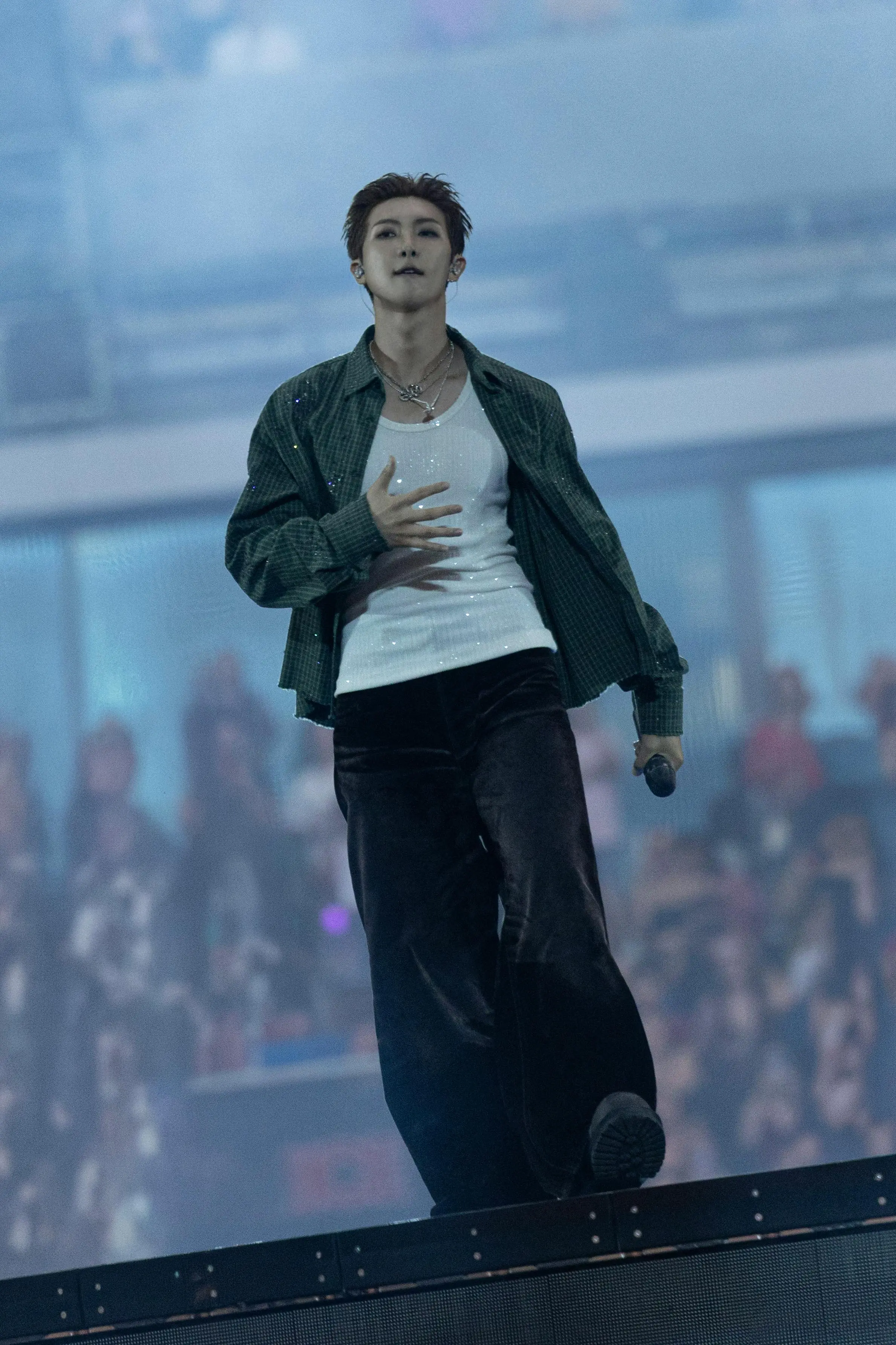 BTS ARIRANG: Inside the Looks of the World Tour Vanity Teen 虚荣青年 RM of BTS wearing a custom Gucci green plaid shirt with crystal details, a white tank top, and brown trousers during the ARIRANG World Tour in Paris.