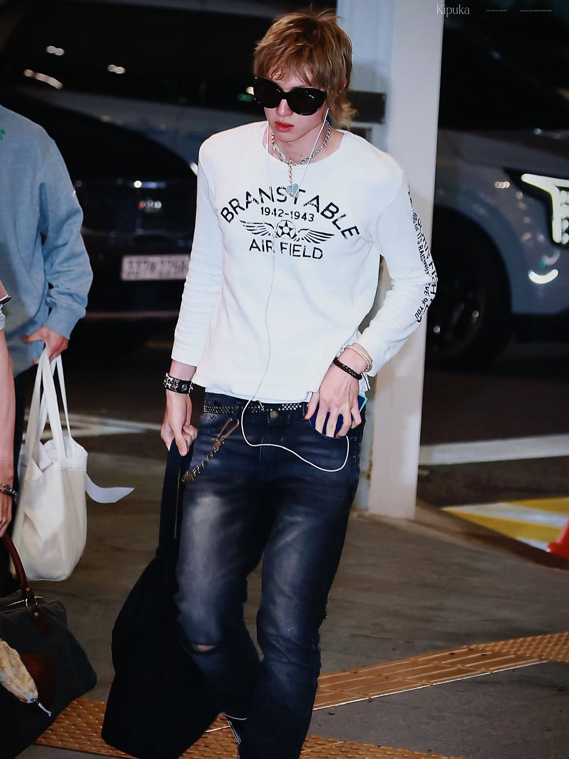 K-pop idol Martin of CORTIS at Incheon Airport wearing a Smack Aspiration T-shirt and TAKAHIROMIYASHITATheSoloist. overglasses