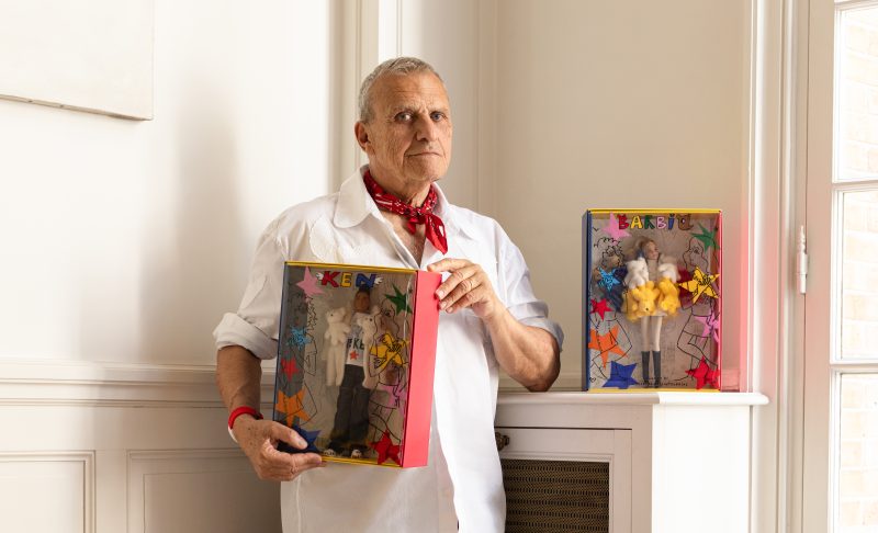 Jean-Charles de Castelbajac holding Barbie and Ken dolls in his studio