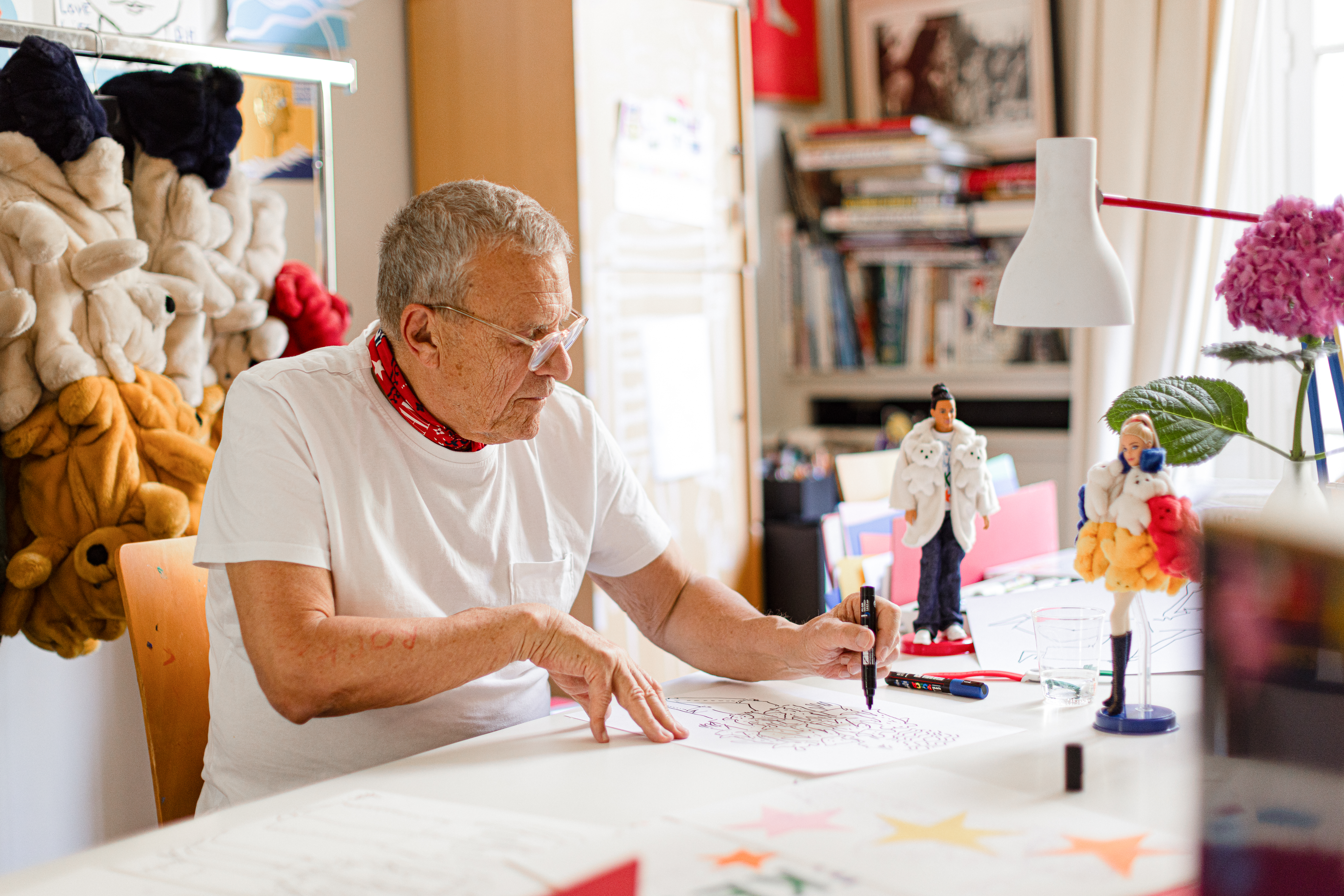 Barbie and Jean-Charles de Castelbajac’s Stunning Fashion Collaboration Vanity Teen Jean-Charles de Castelbajac drawing in his studio with Barbie and Ken dolls beside him